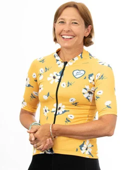 A cycle jersey with a buttercup yellow body with scattered white flowers | Cycling Jersey