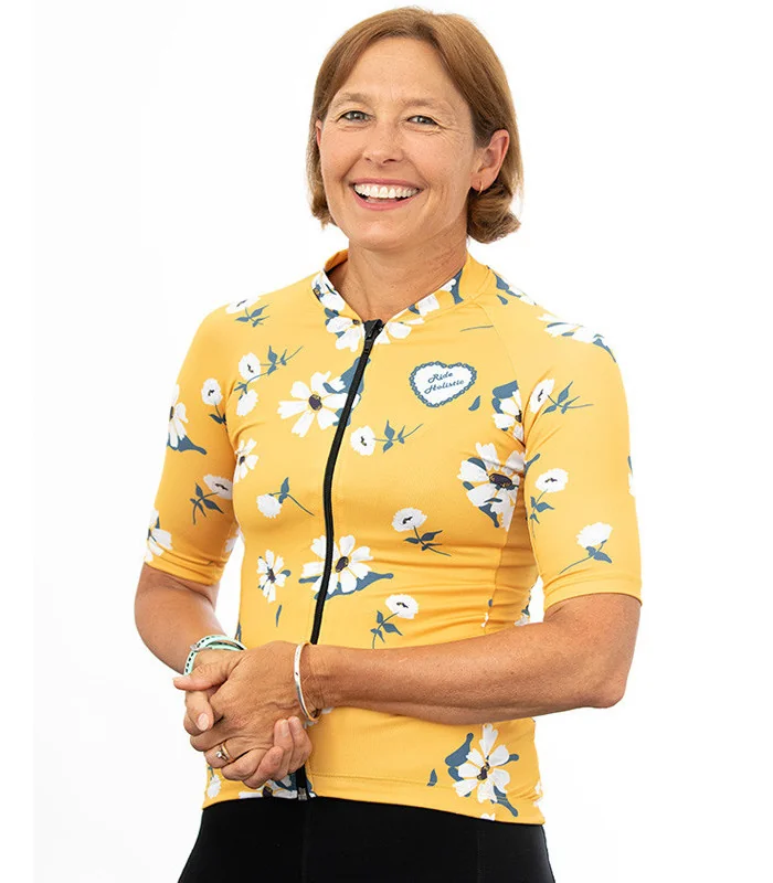 A cycle jersey with a buttercup yellow body with scattered white flowers | Cycling Jersey