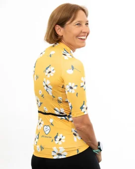 A cycle jersey with a buttercup yellow body with scattered white flowers | Cycling Jersey