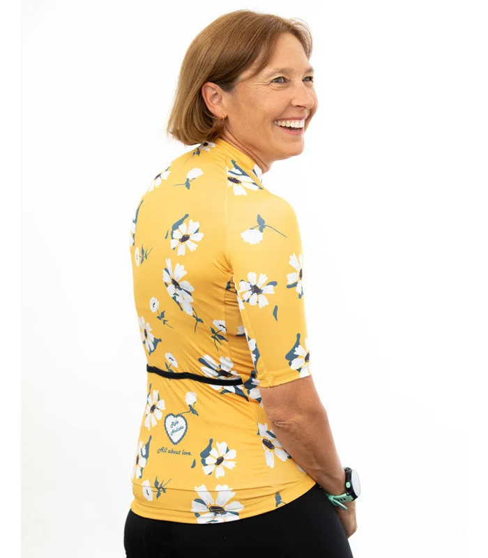 A cycle jersey with a buttercup yellow body with scattered white flowers | Cycling Jersey